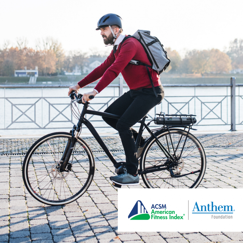 man in red sweater riding a bike with a backpack