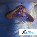 man in bed grabbing his head, frustrated that he cannot sleep
