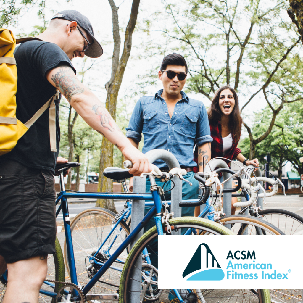 three people locking bikes to a bike rack